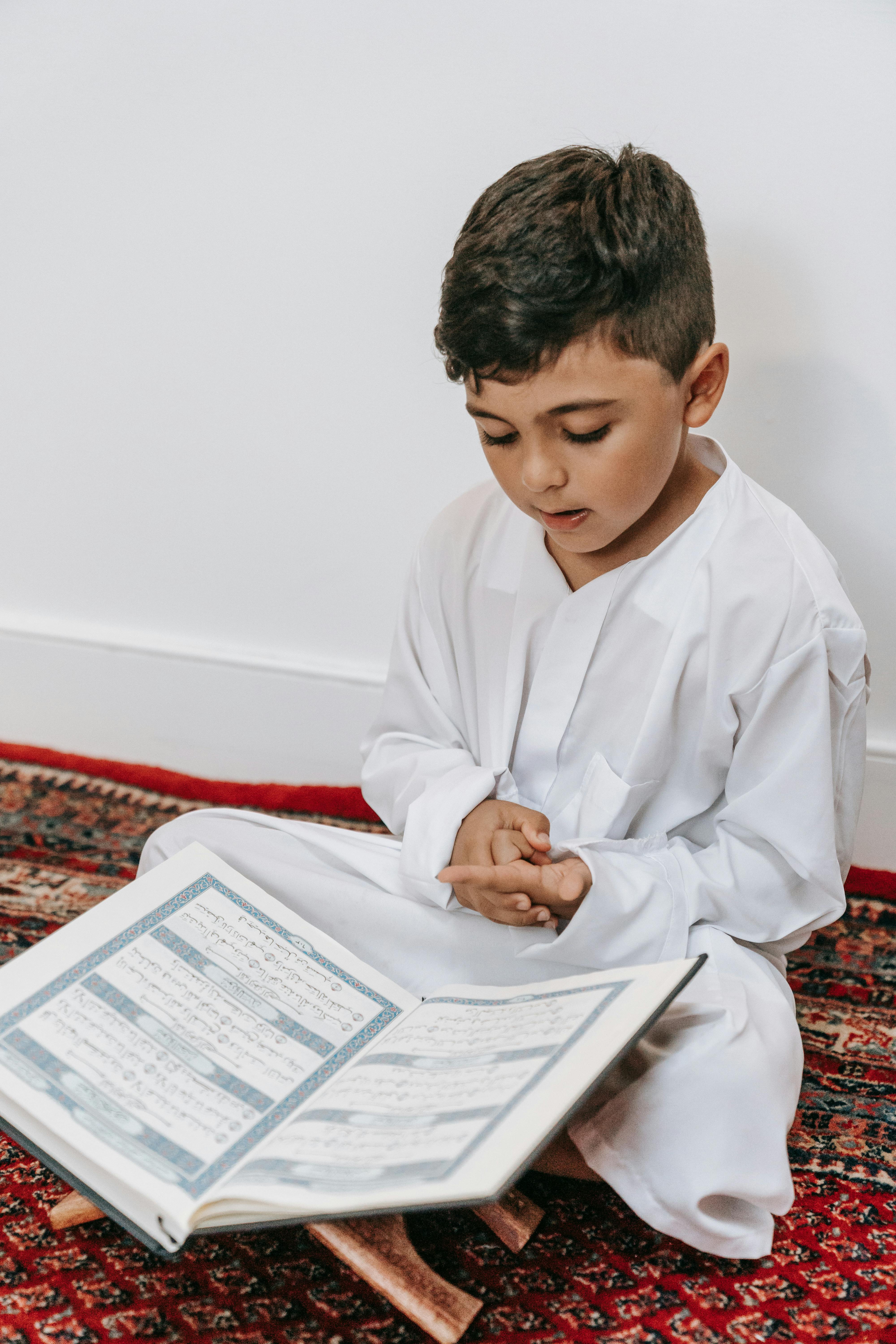 Smiling child holding Quran - Islamic education at Dugsi Qur'an